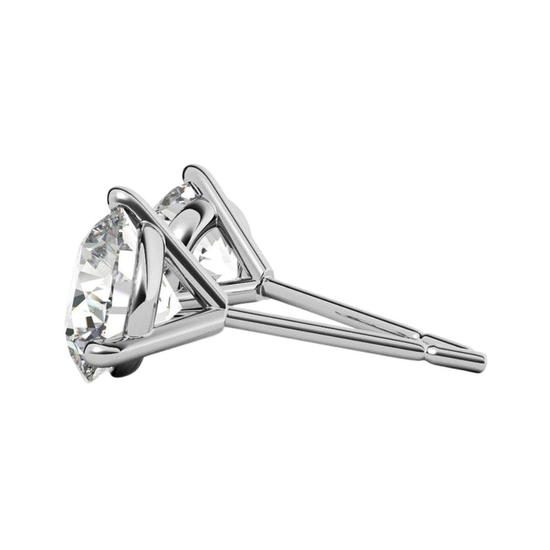 Side view of white gold martini studs with cz stones on a white background.