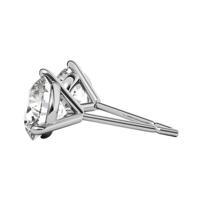 Side view of white gold martini studs with cz stones on a white background.