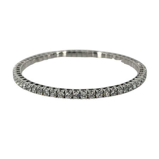White gold bangle bracelet with a continuous setting of brilliant round diamonds.