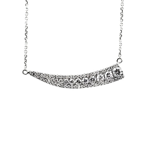 White gold necklace adorned with round diamonds that smoothly tapers as it goes right to left.