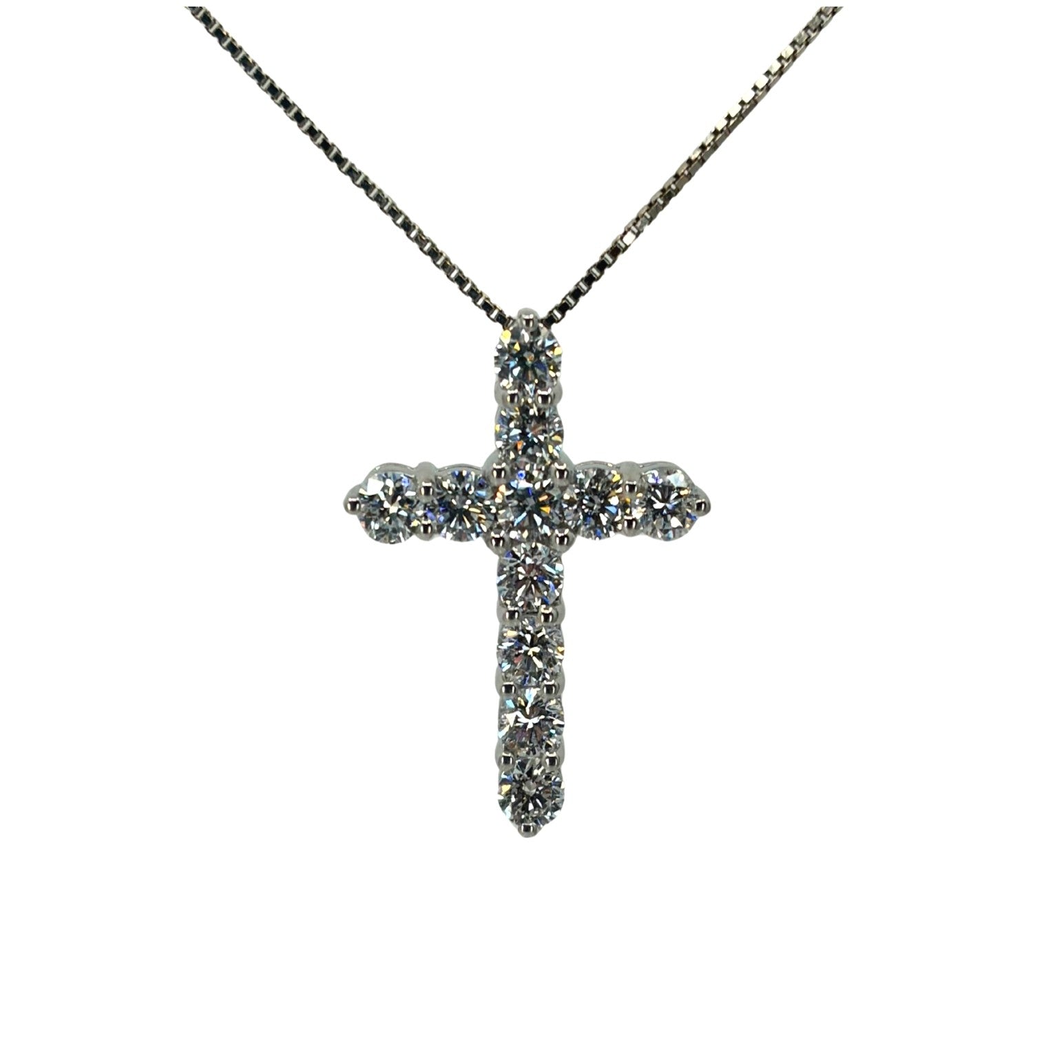 White gold cross pendant with 11 lab grown diamonds suspended from a white gold box chain.