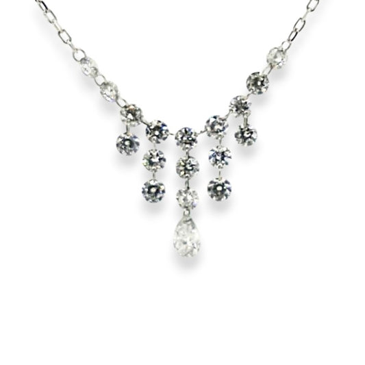 Delicate white gold diamond necklace featuring hanging round stones and a central teardrop accent of a pear shaped diamond.