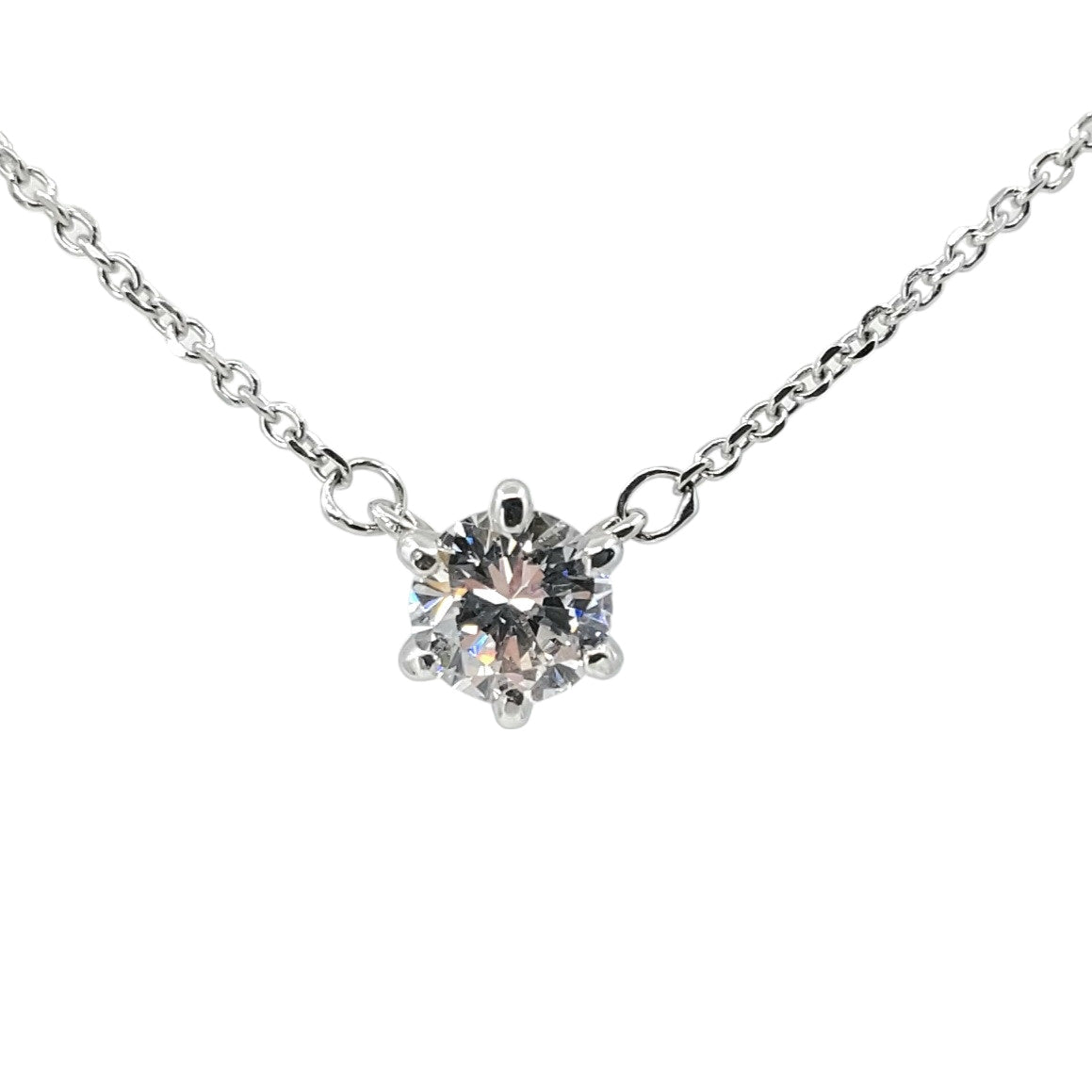 Delicate white gold necklace set with a central singular round diamond.