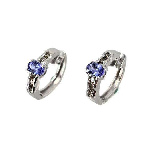 White  gold huggy hoop earrings set with vibrant violet-blue tanzanite stones.