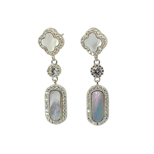 Pair of white silver dangle earrings with clover-shaped top and oval-shaped bottom.