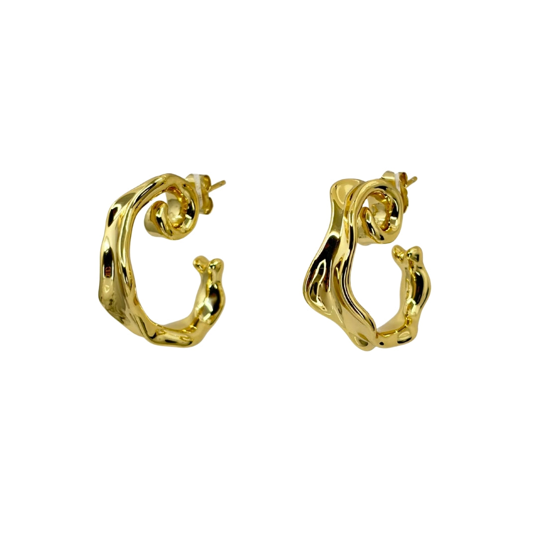Yellow sterling silver hoops in a wavy geometric shape that winds around the ear.